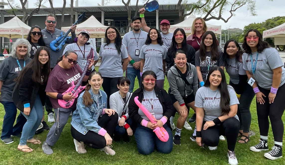 group of students smiling, facing camera during athletics fair