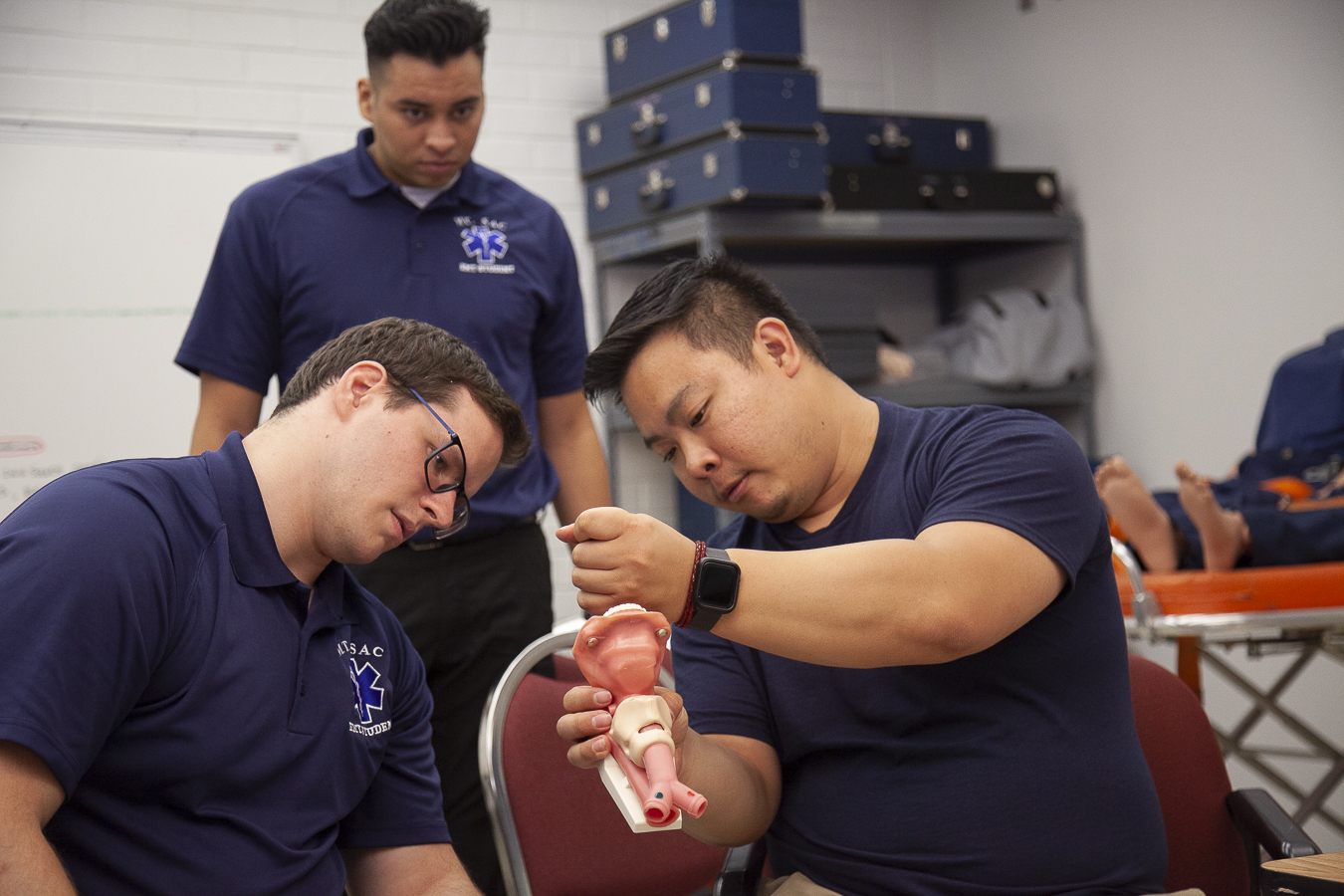 emt instructor demonstrating technique 